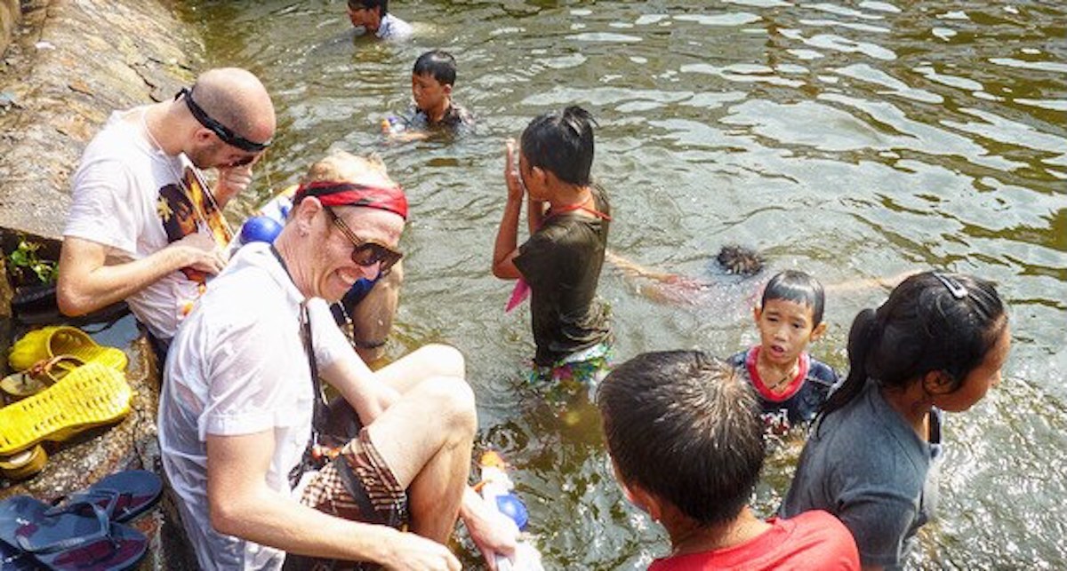 Tourists smile in a moat during Songkran festival