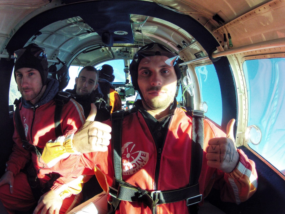 2 men looking nervous in a skydiving plane