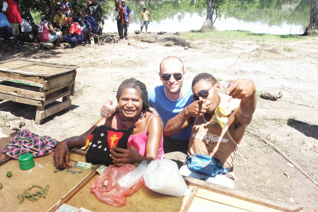 Tourist poses with locals in Papua New Guinea