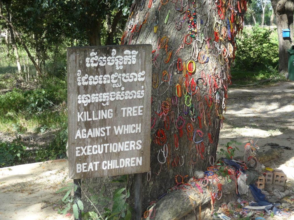 Memorials hang from the killing tree in the killing fields of Cambodia