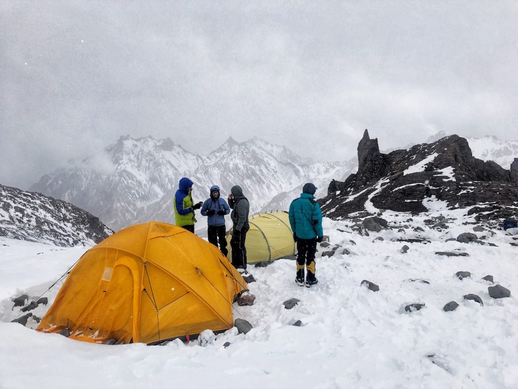 Climbers talking at camp on Aconcagua during a snowstorm