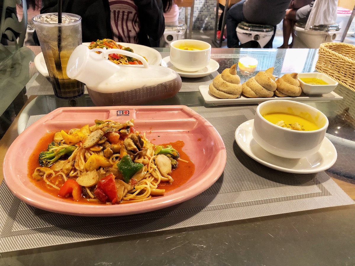 A stir fry alongside poo-shaped bread in Taipei, Taiwan