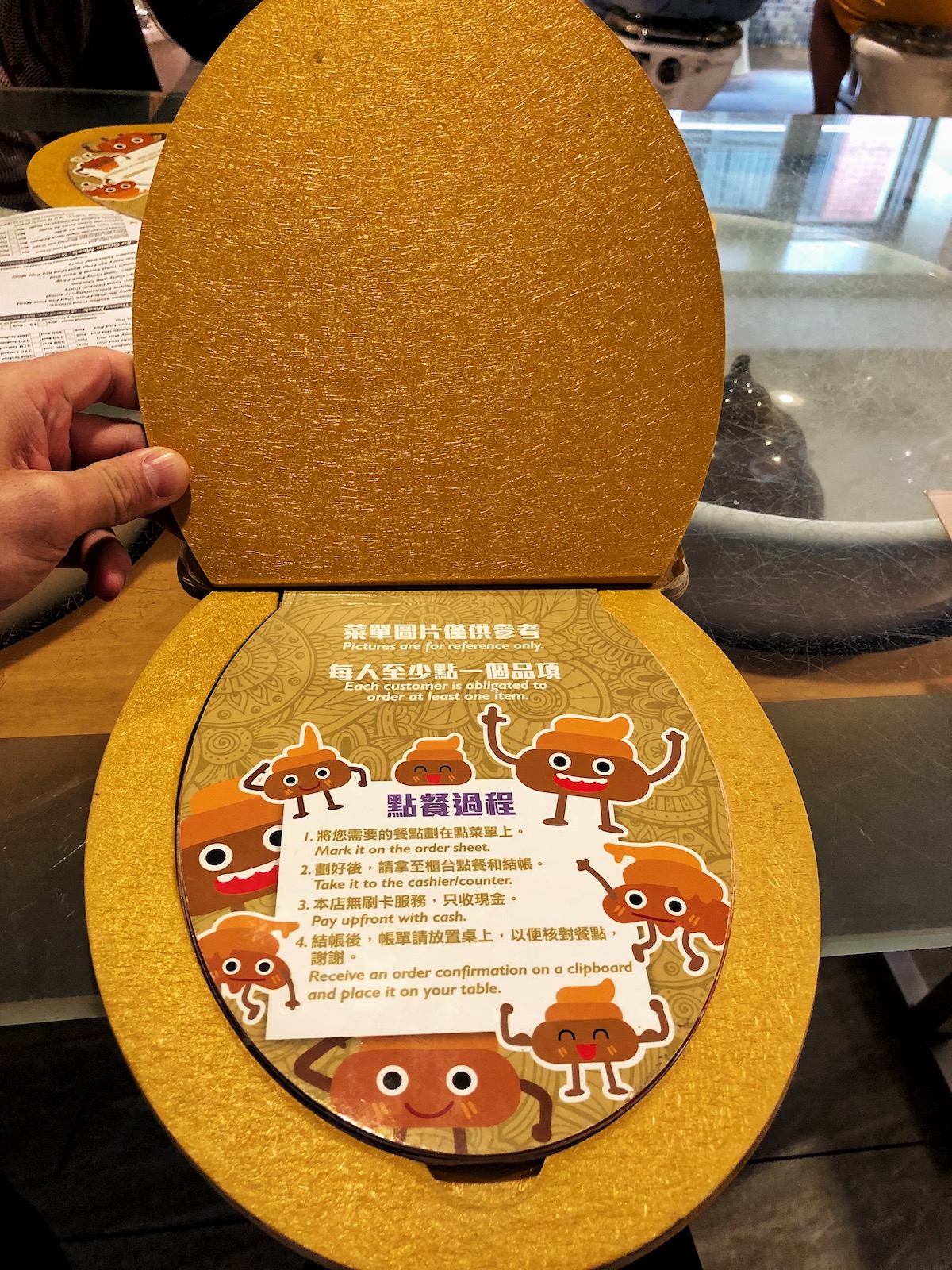 A menu and instructions in the shape of a toilet seat