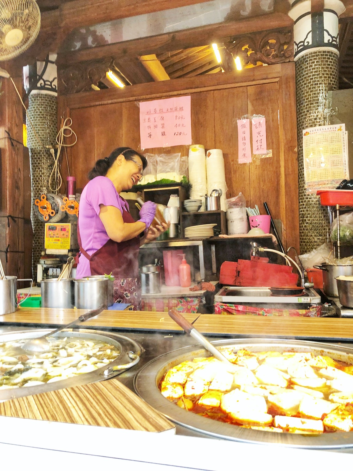 A lady street seller bursts into hysterics while cooking stinky tofu in Taiwan