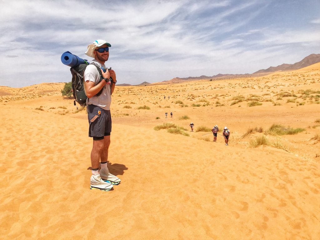 Man posing in the desert with sport gear