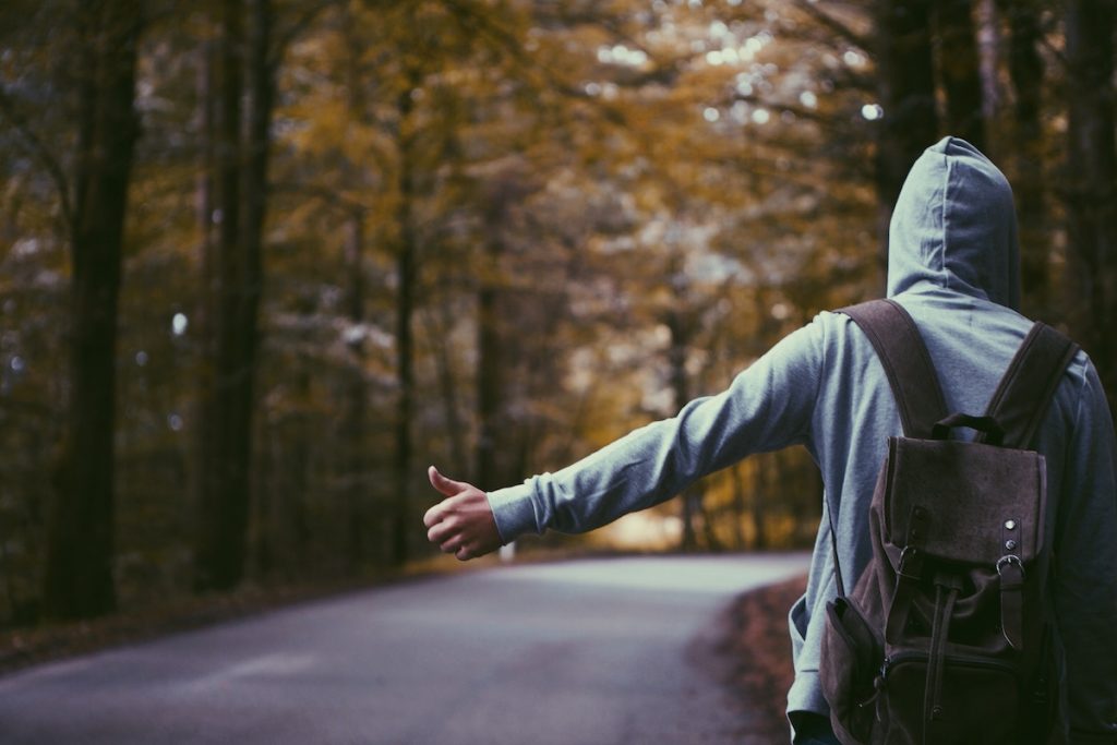A man travelling alone hitchhiking