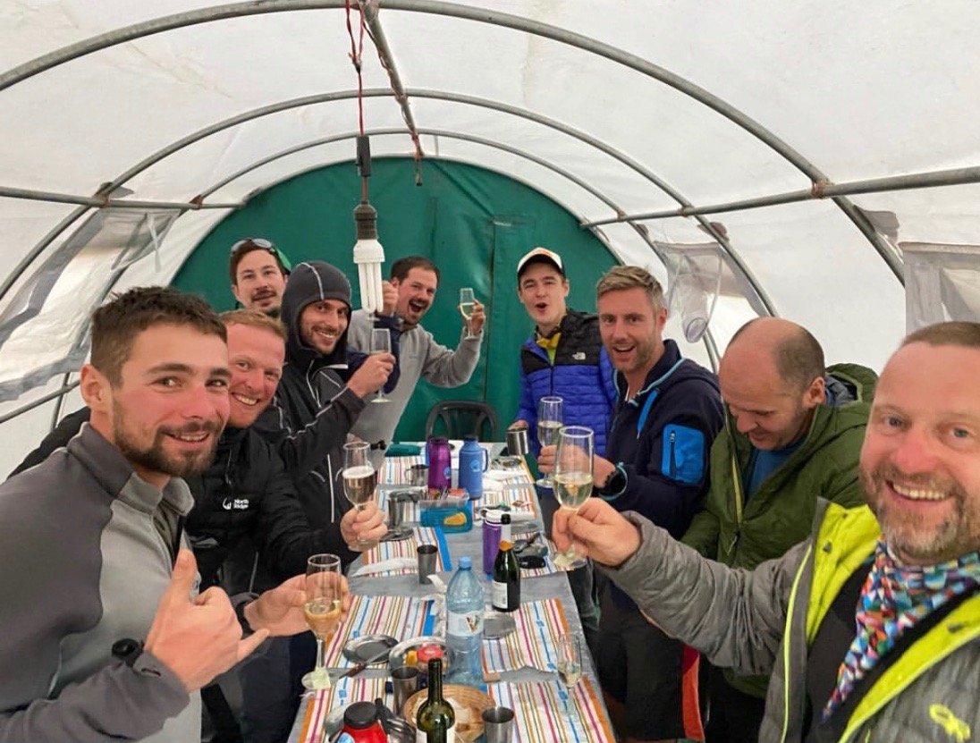 Climbers toast champagne in a tent on Aconcagua during New Year's Eve