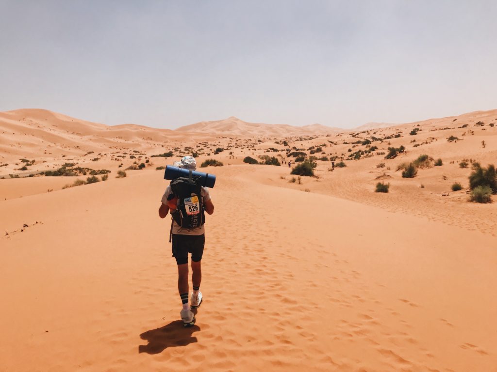 Man walking through Sahara Desert at Marathon des Sables