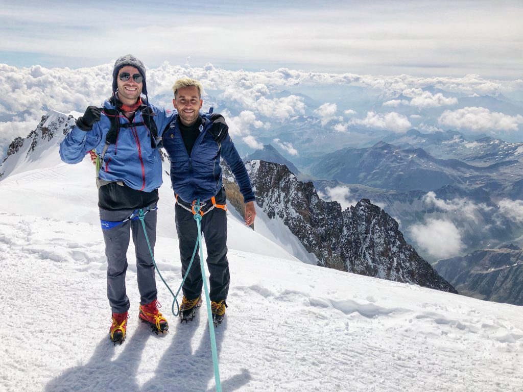 Two guys standing on top of Mont Blanc, France