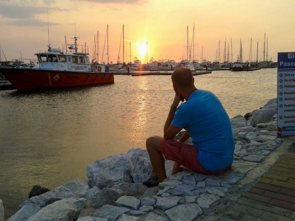 man looking at a sunset in santa marta colombia