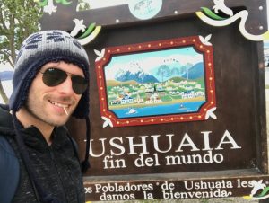 tourist at Ushuaia sign