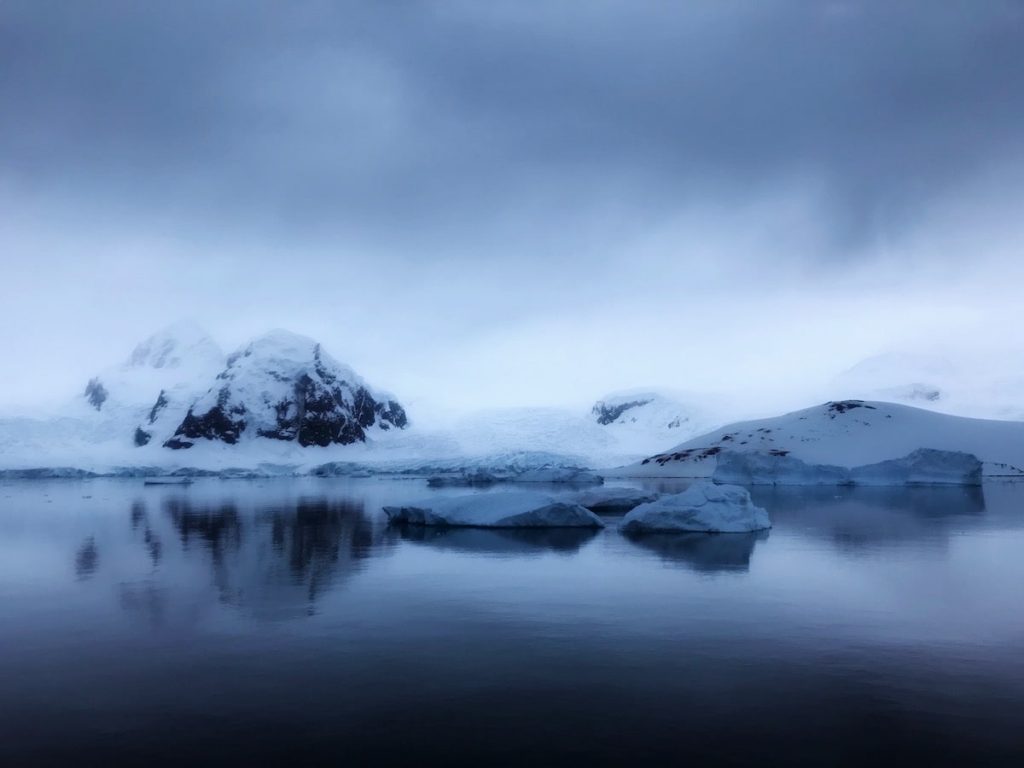Misty view of snow-capped rocks in Antarctica