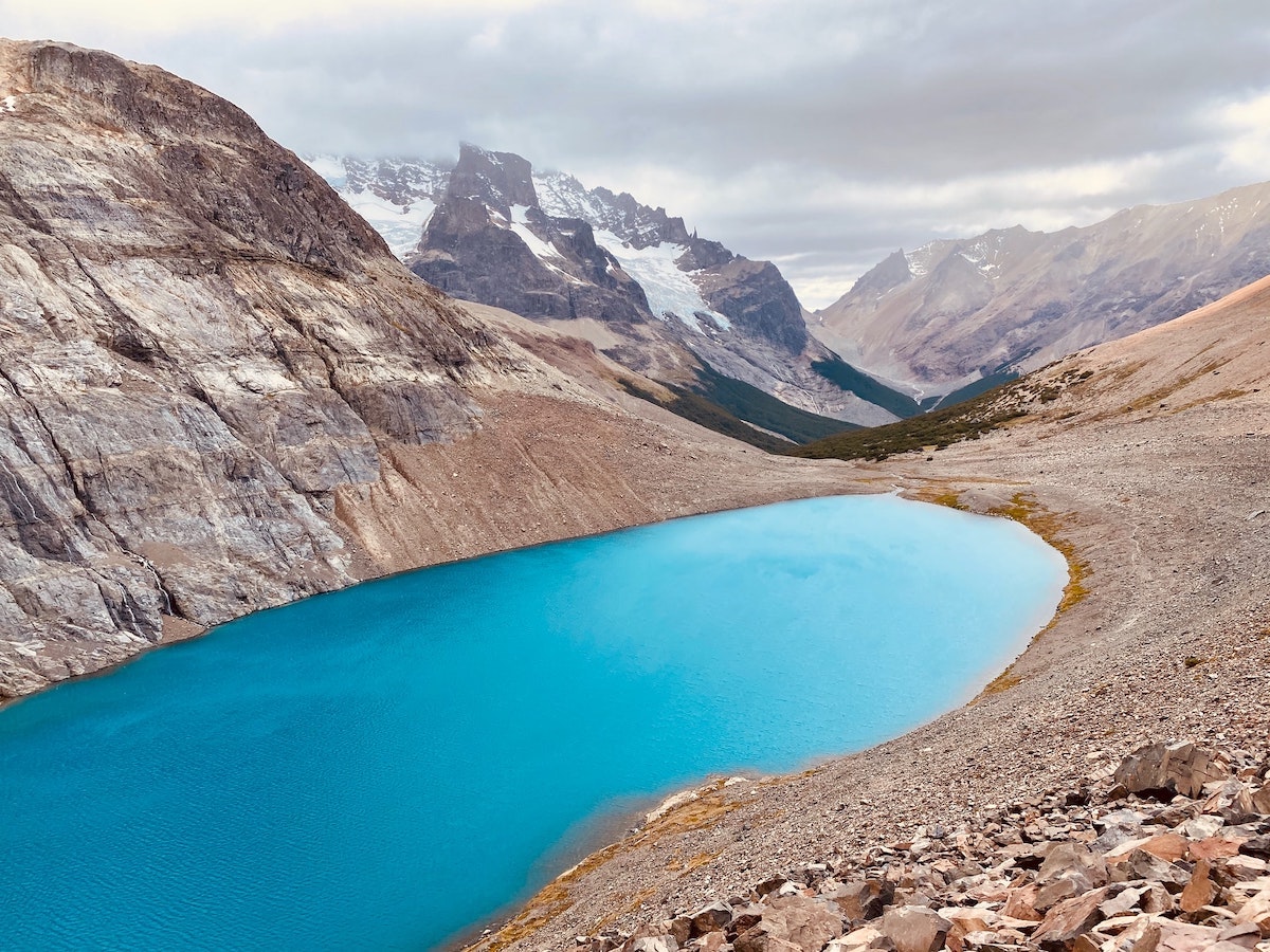 Striking blue lake surrounded by brown rocky mountains in Cerro Castillo, Chilean Patagonia