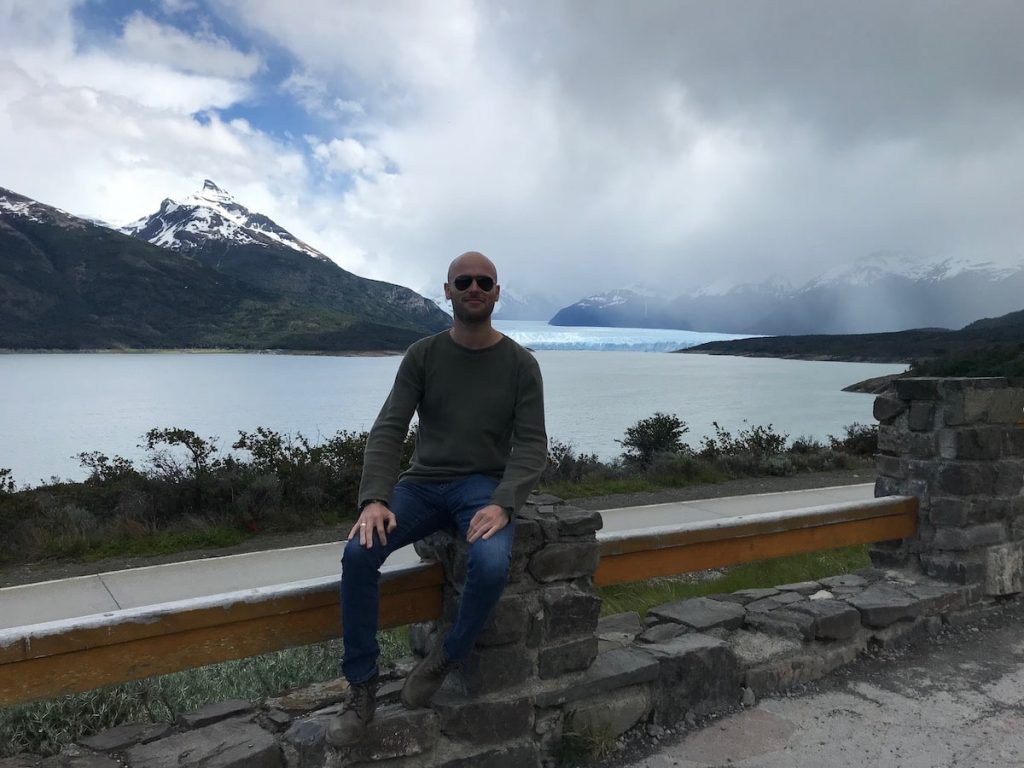 Male tourist sitting in front of a beautiful landscape in El Calafate, Patagonia