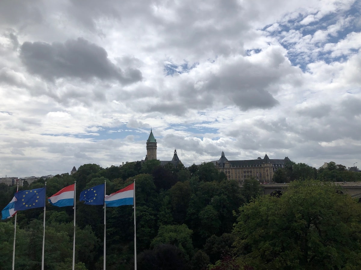 Luxembourg and European Union flags blow over Luxembourg City