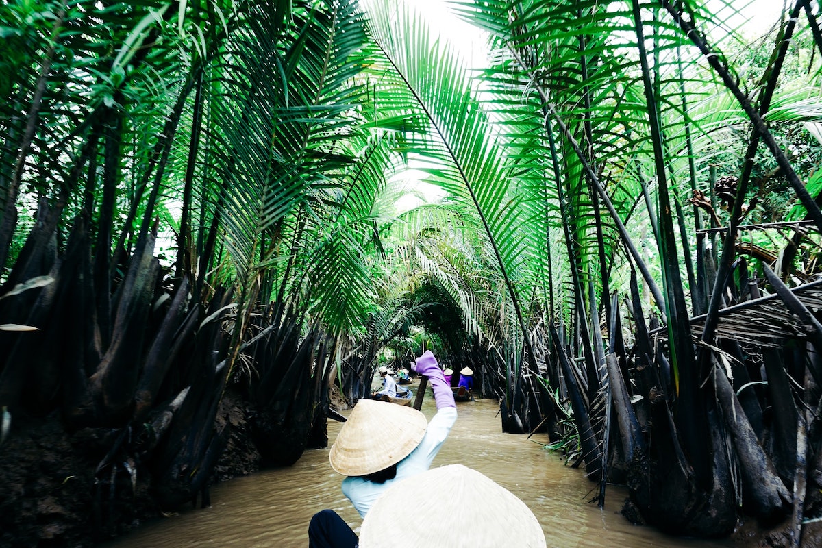 Local lady rowing in the Mekong Delta, Vietnam.