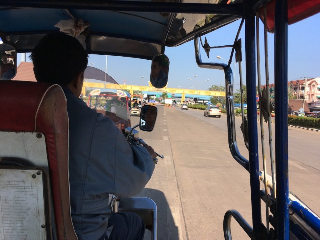 Approaching the Laos border from a tuk tuk during an overland visa trip from Thailand