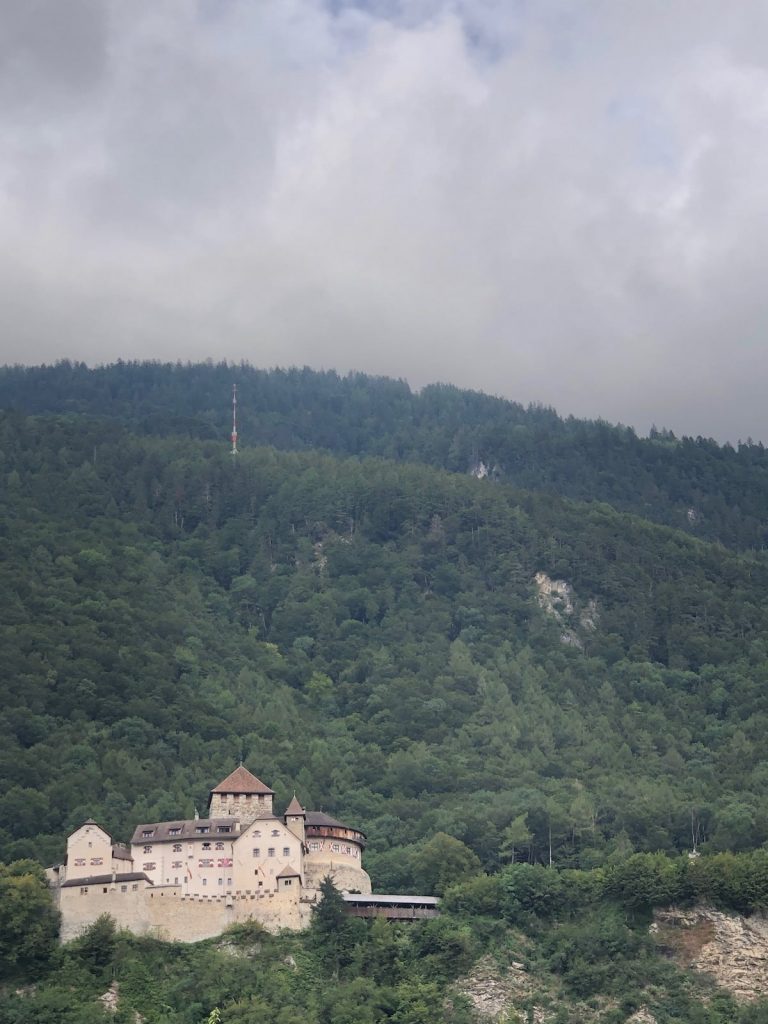 Vaduz Castle with a backdrop of trees and cloudy sky