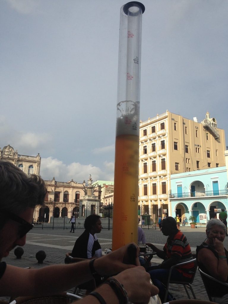 Tourist drinking beer at Plaza Vieja, in Havana, Cuba