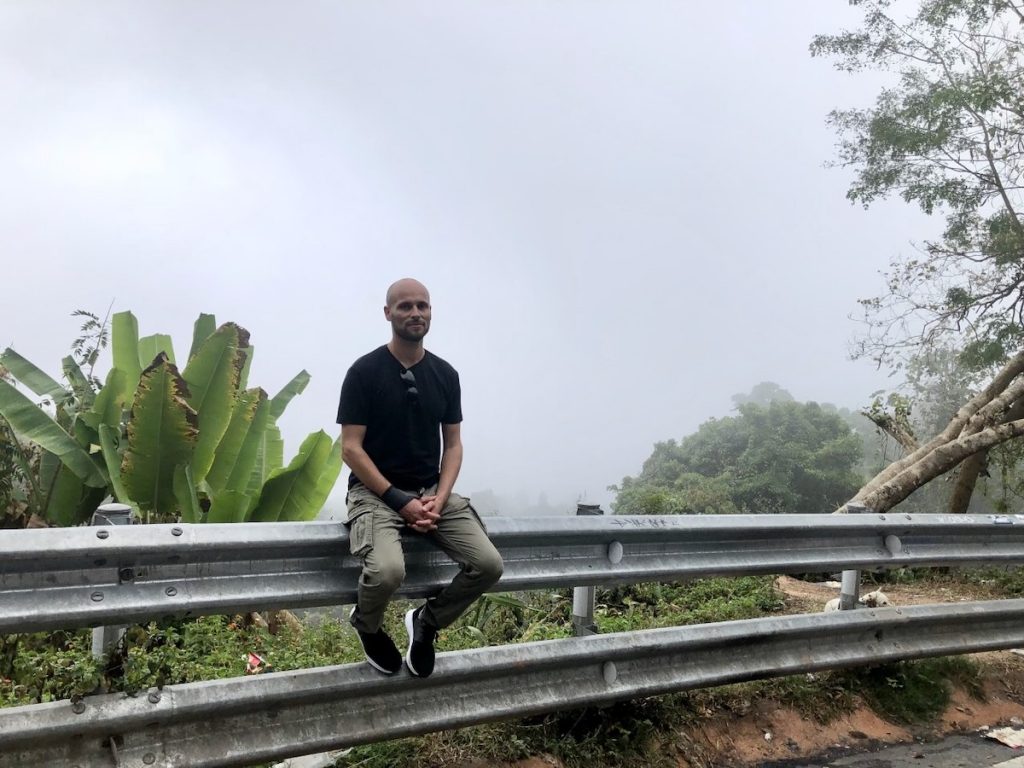 Man posing in front of misty sky