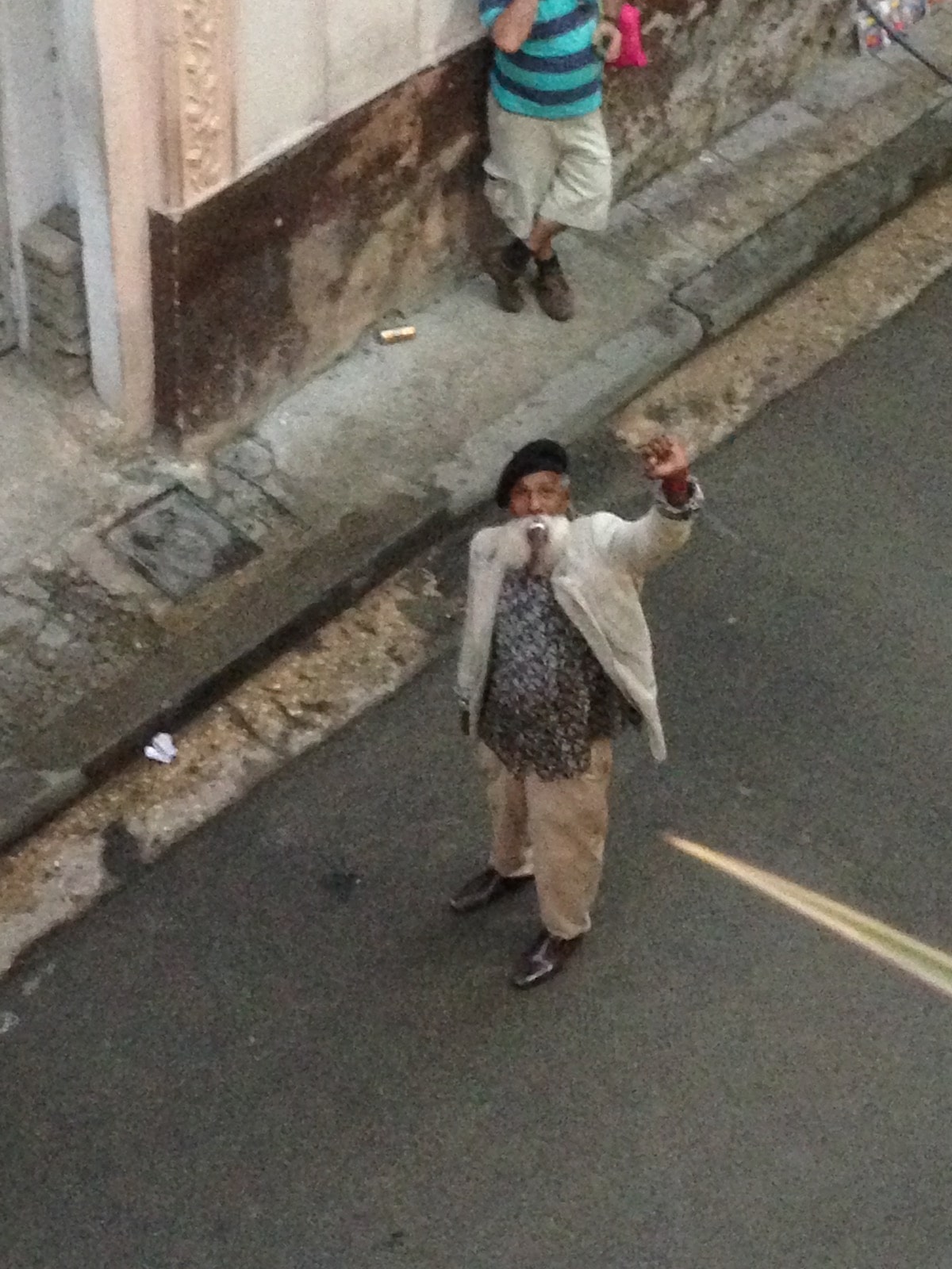 Old Cuban man waving in downtown Havana