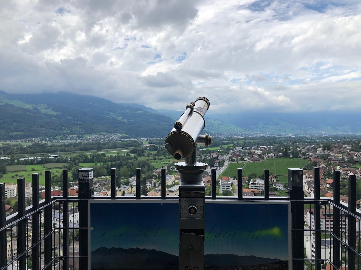 A telescope overlooking Vaduz, Liechtenstein on a clear sky day