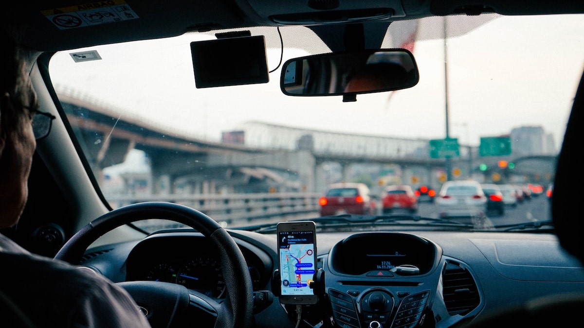 Driver looks out of car window into the traffic