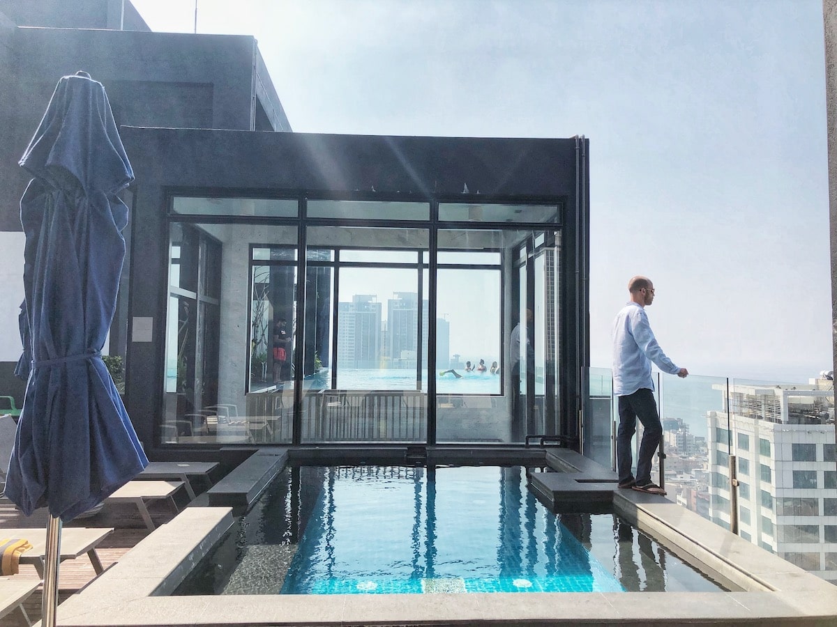 Man standing at pool while overlooking the Sri Lanka's capital