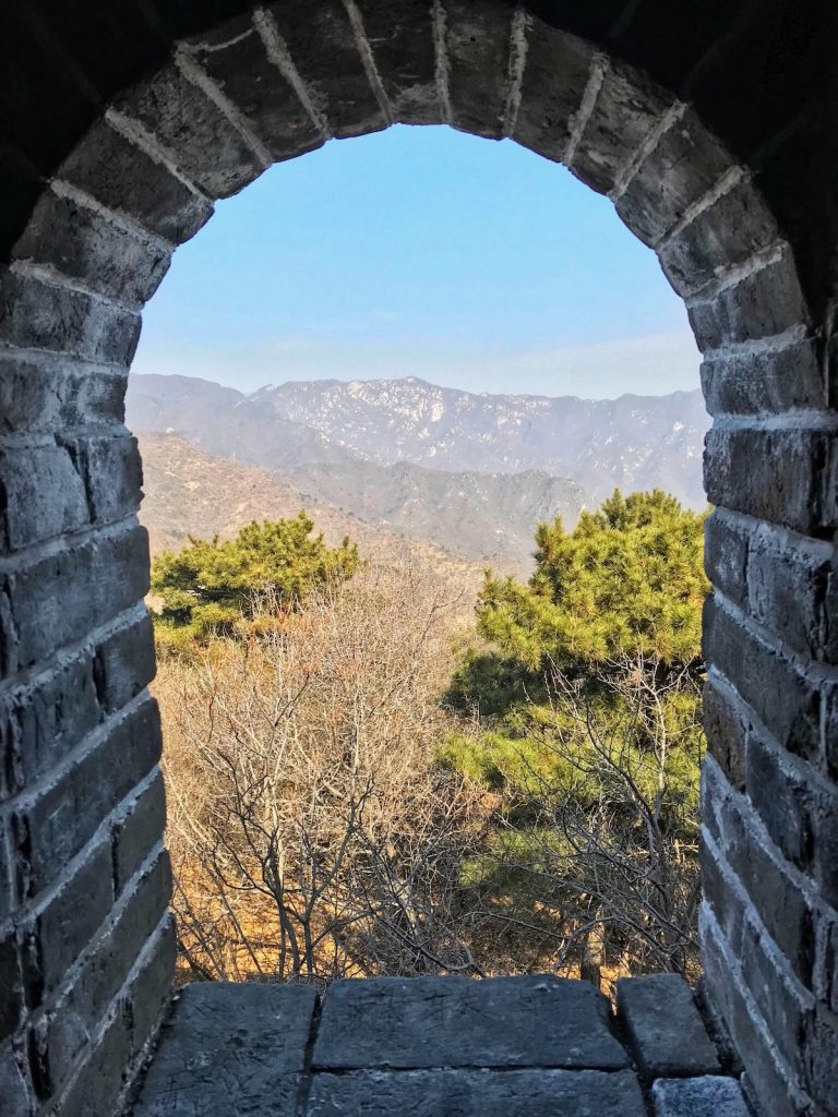 An archway looking out into mountains and trees. 