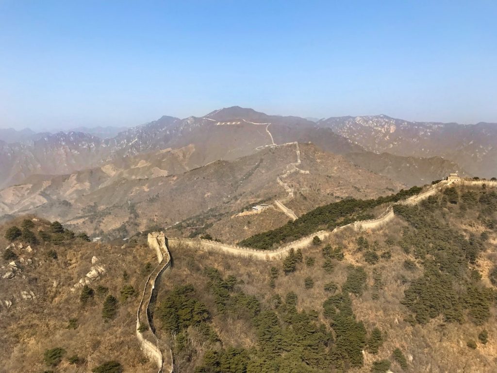 Best Place To See Great Wall of China (No Crowds, No Worries!) • How long is the great wall of china Landscape view of the mountains of the Great Wall of China on a clear day.