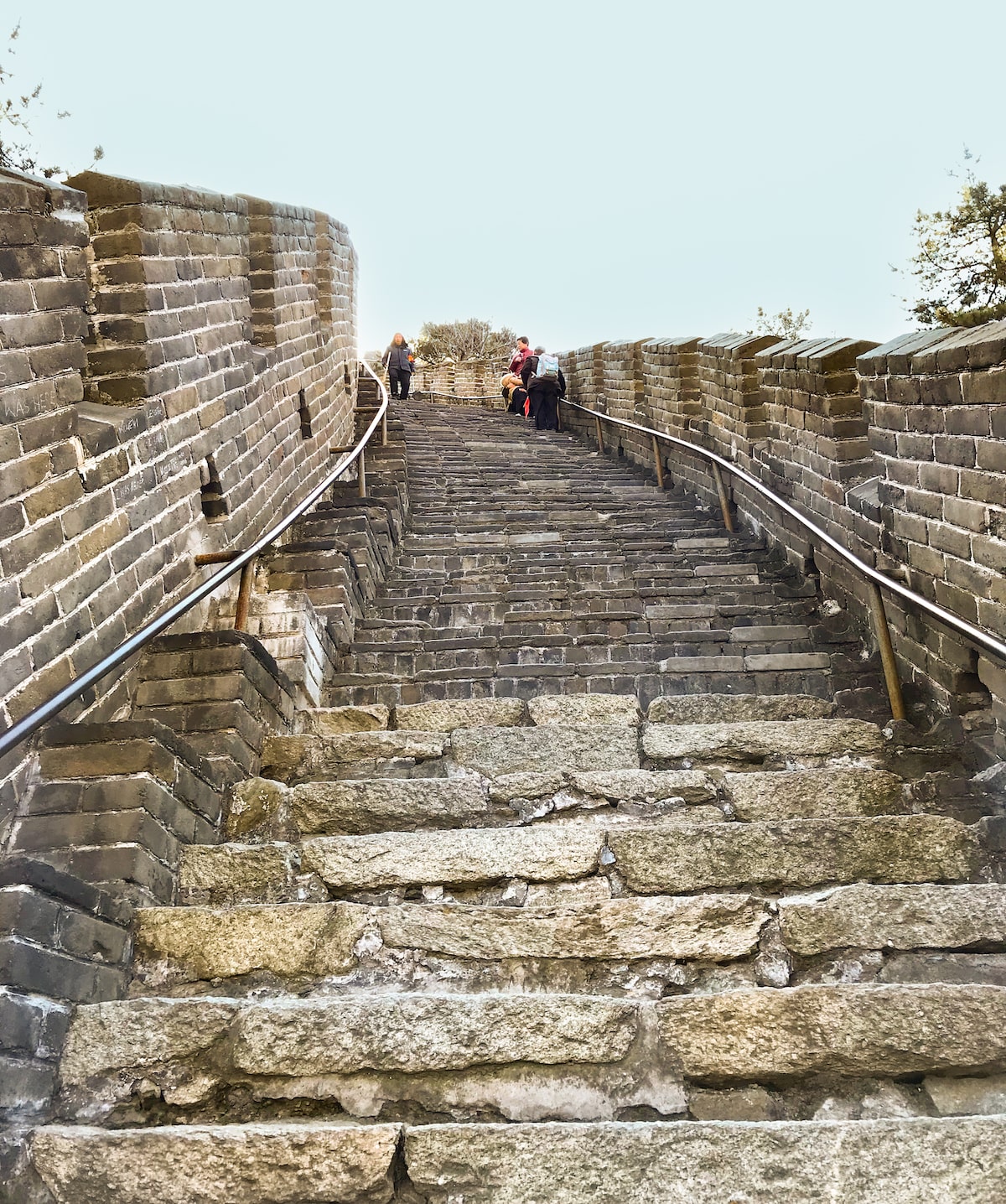 Steep curved steps with hand railings. 