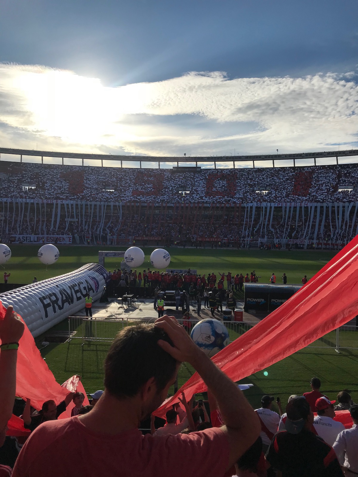 A packed football stadium in red and white contrast spells out the number "1901."