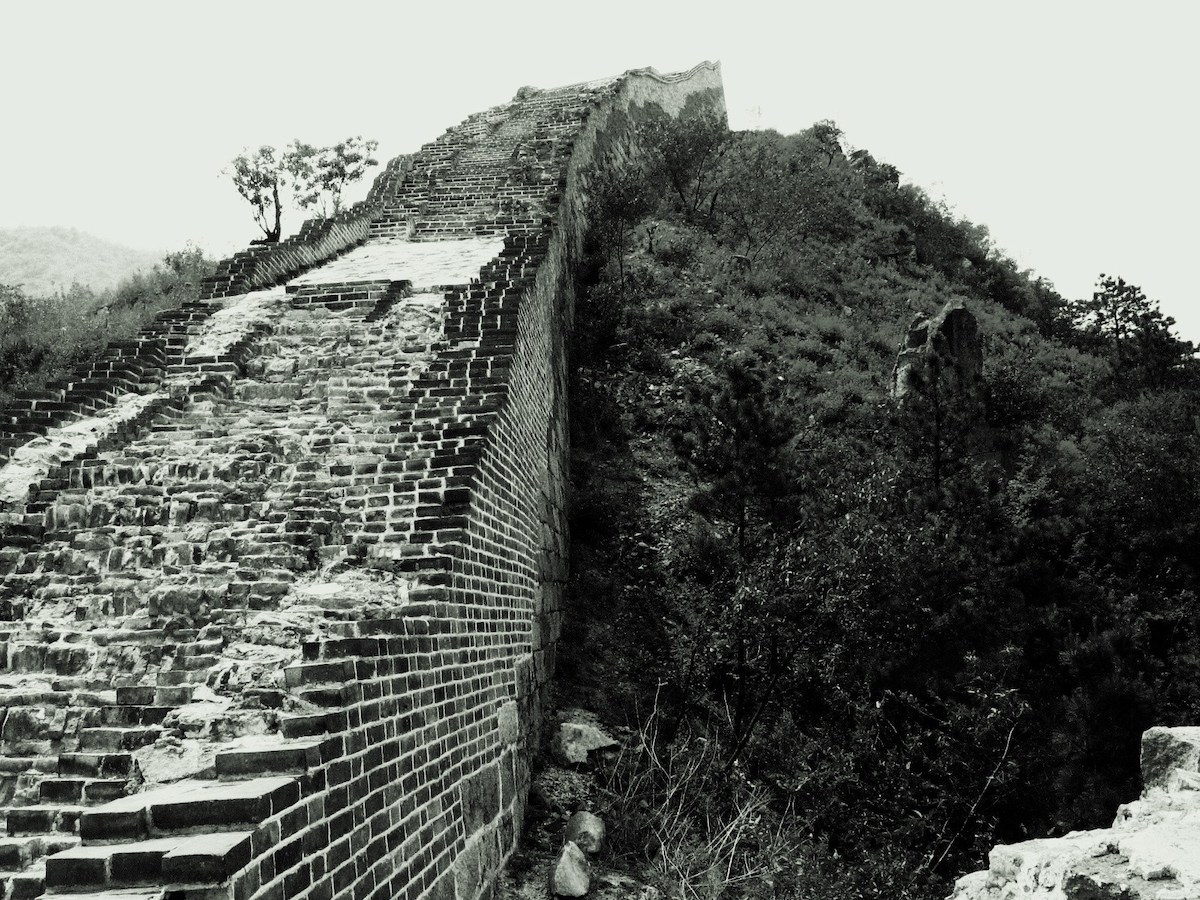 Broken parts of the Great Wall of China, in black and white