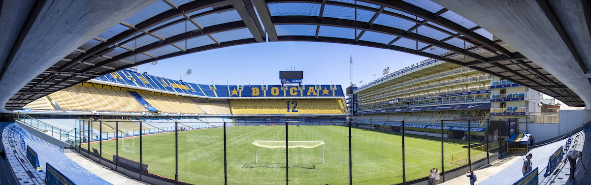 An empty football stadium in Buenos Aires, with the words "Boca 12" on the seats.