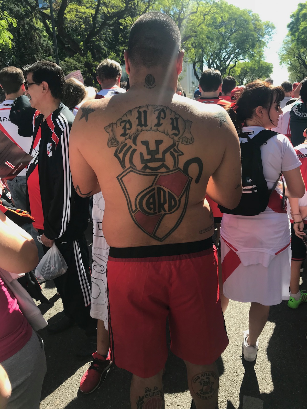 A football fanatic shows off a large crest of his club's crest, tattooed on his back in Buenos Aires, Argentina.