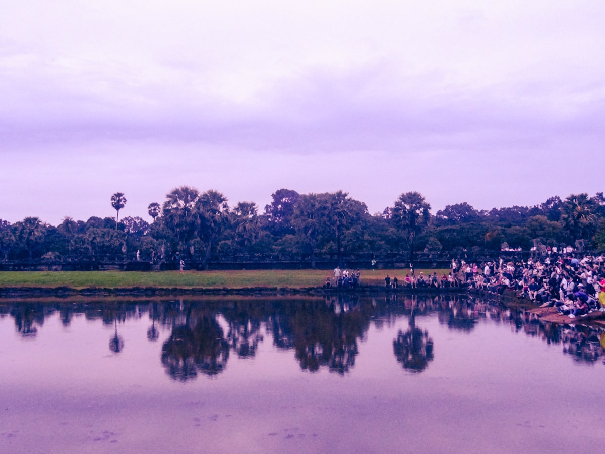 A crowd of tourists wait for sunrise at Angkor Wat in Cambodia 