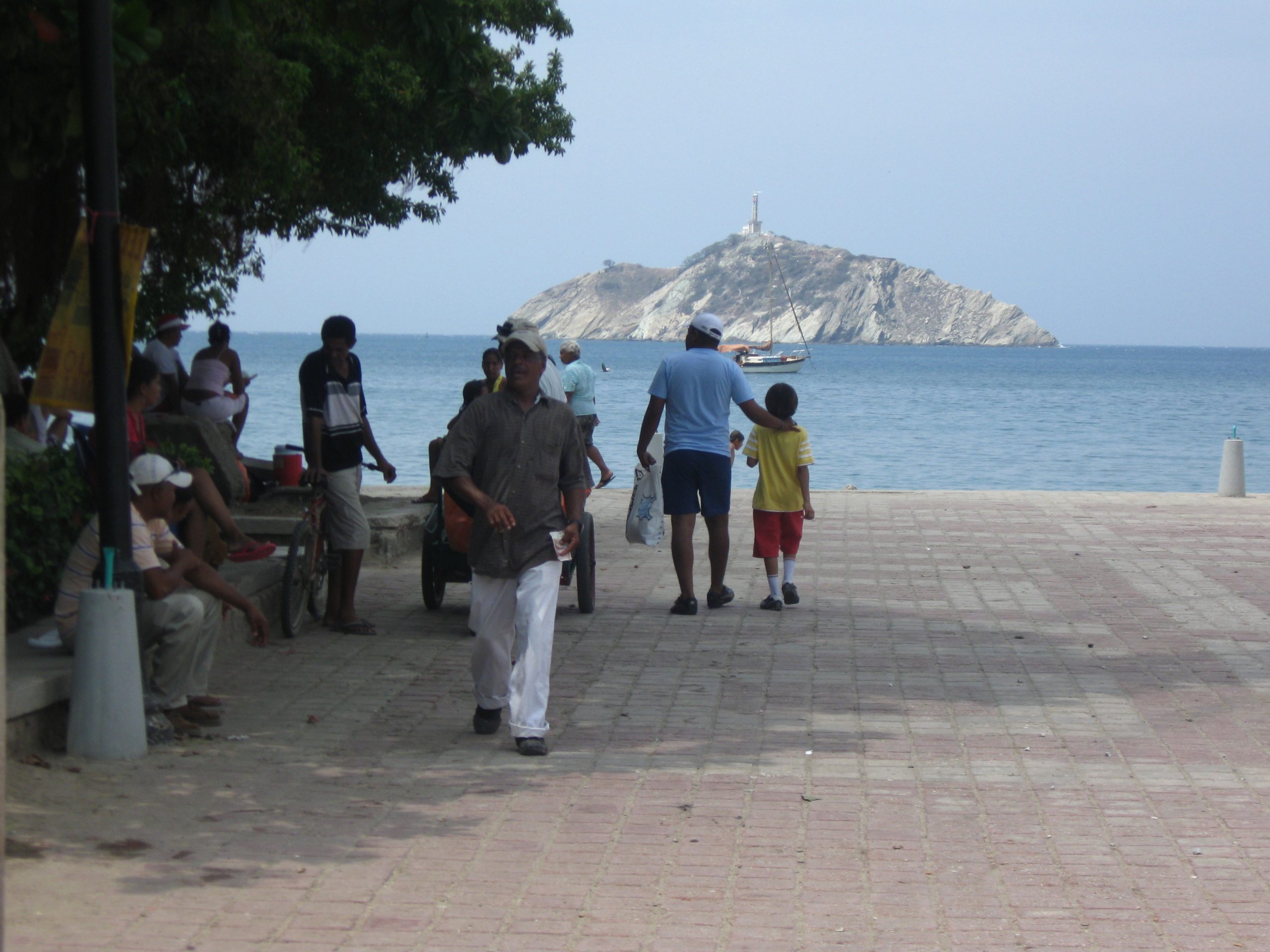 A man walks with his son on a port walkway in Santa Marta, Colombia.