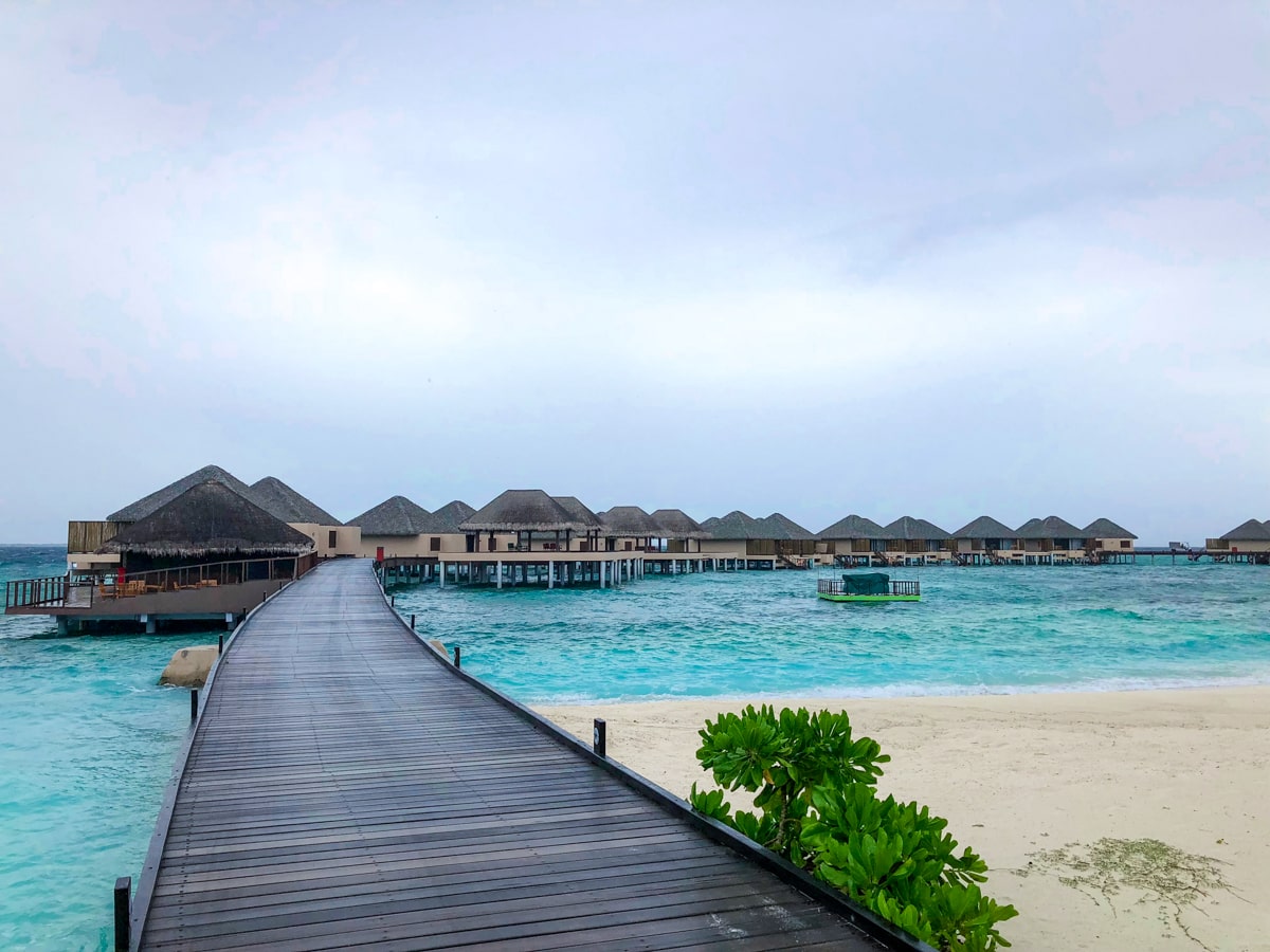 A windy wooden walkway leading to sea bungalows in the Maldives