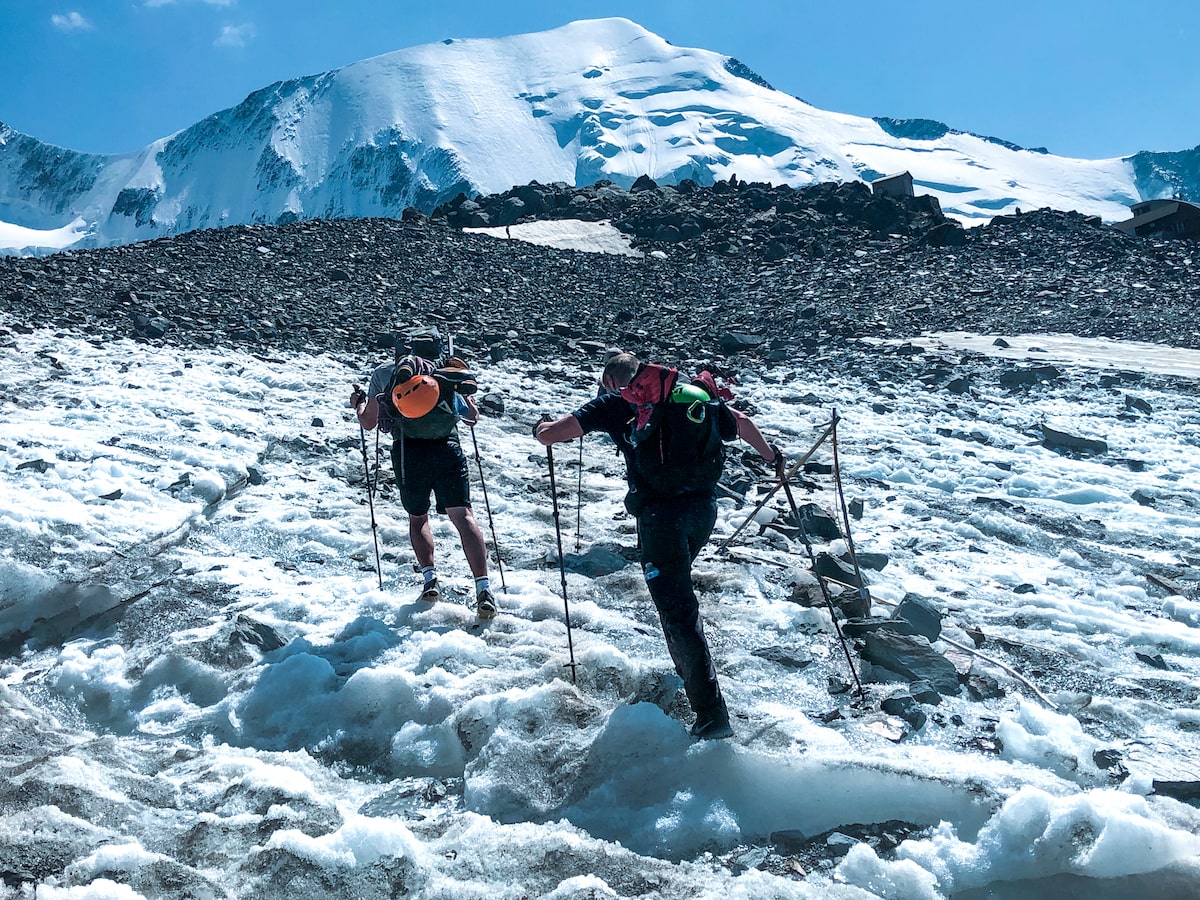 Two men with walking poles battle through the ice in Mont Blanc, France.