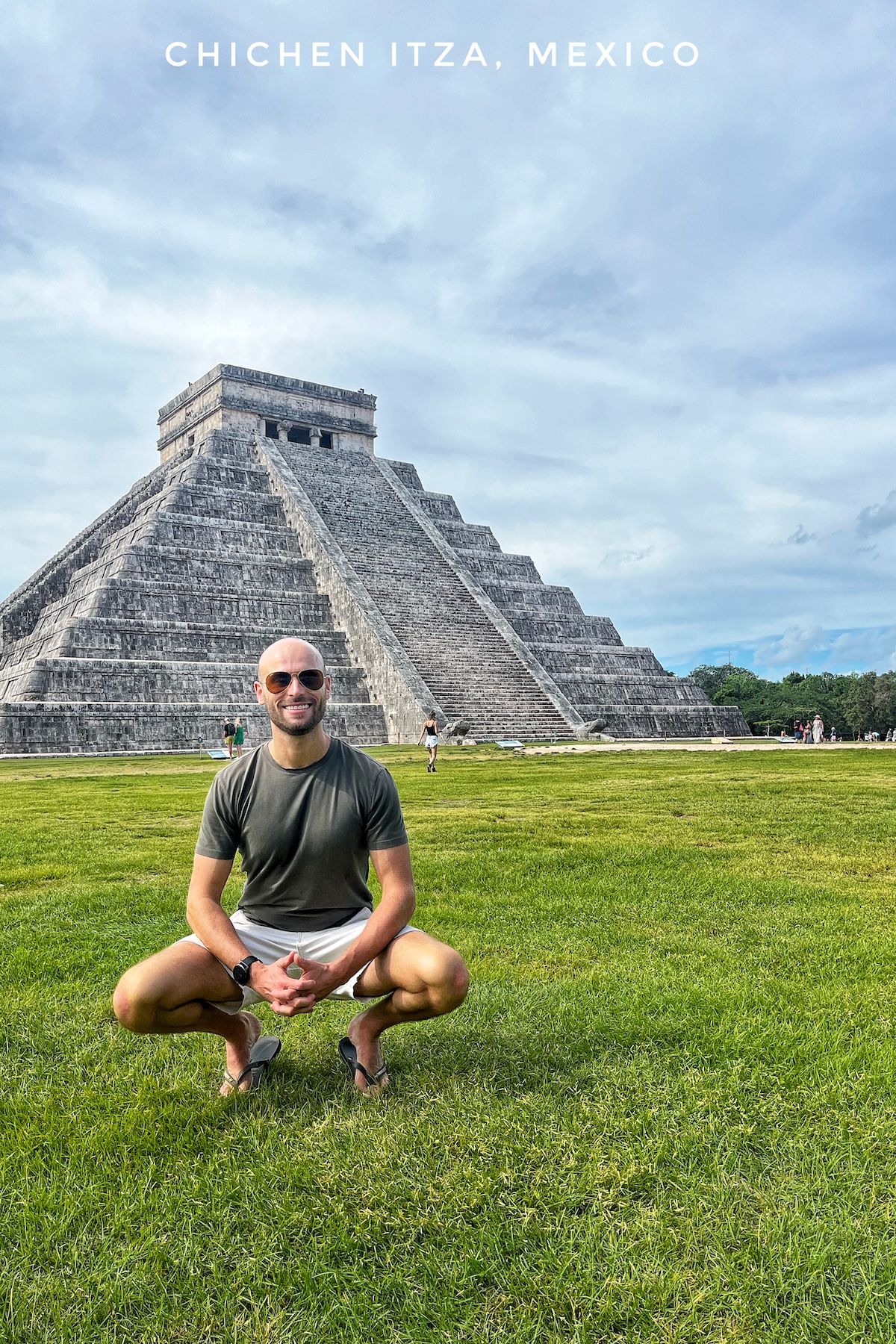  Male tourist poses in front of Chichen itza of Mexico,