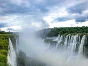 Mist falls over both sides of the Iguazu Falls Waterfalls, which are shared between Argentina and Brazil