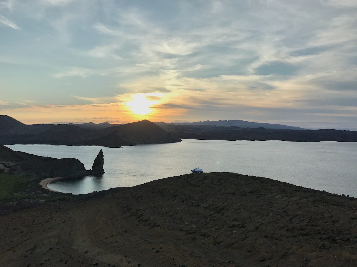 A cruise ship floats at sunset on El Barranco Island during a 5 days Galapagos Islands cruise