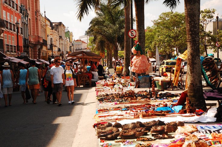 A busy sidewalk with products being sold on the ground in Lapa, a barrio of Rio de Janeiro in Brazil