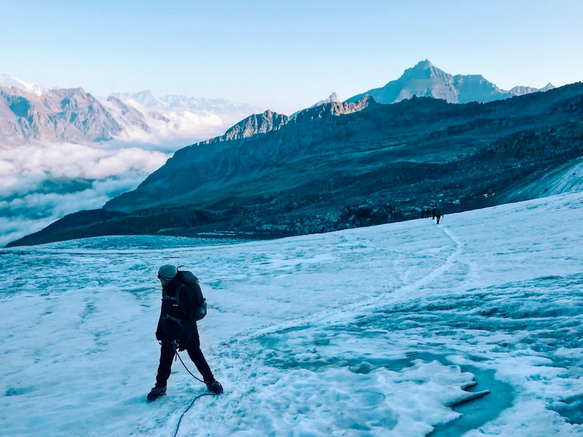 A climber looks up into the French Alps as the rest of the tour walk to join him on the ice.