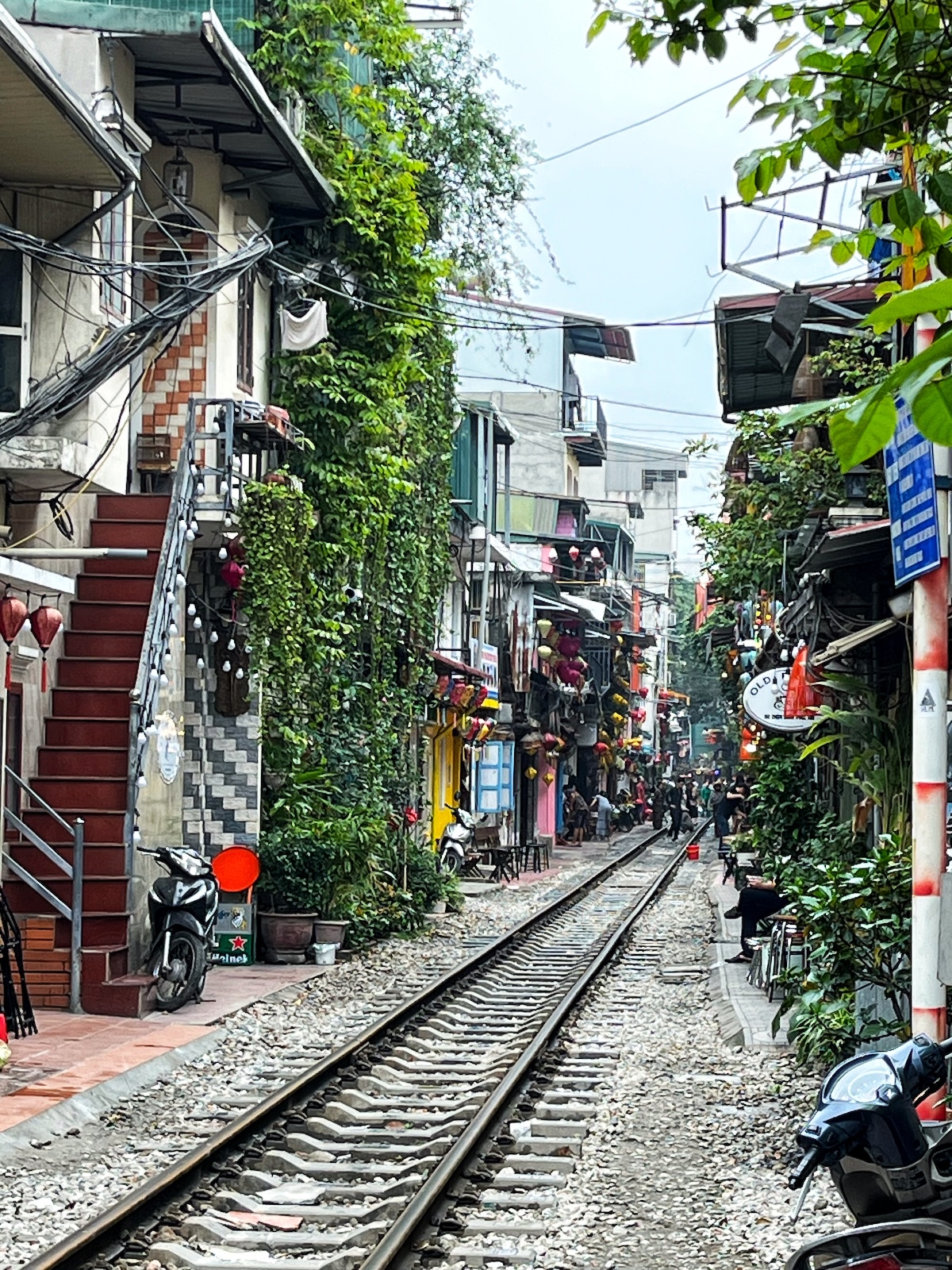 A train track runs through a busy street in Hanoi, Vietnam