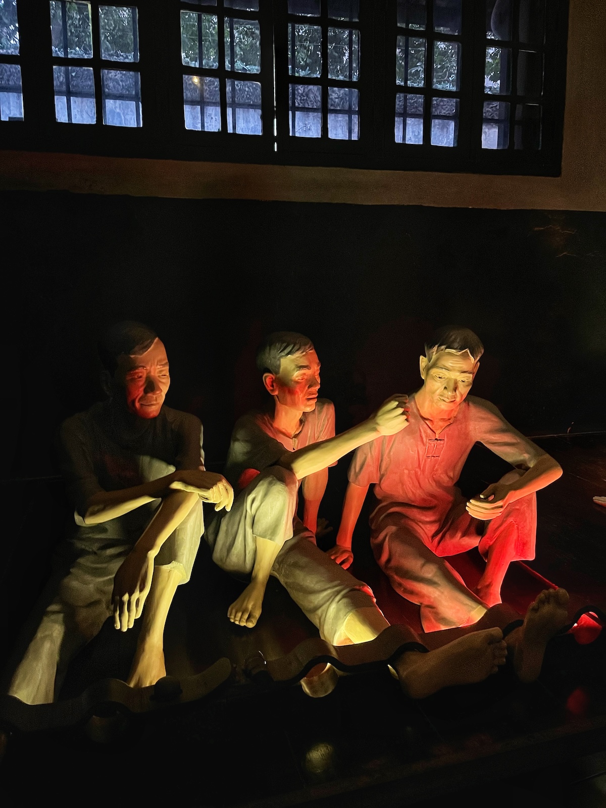 Figures of 3 male prisoners in Hoa Lo Prison Museum, Hanoi