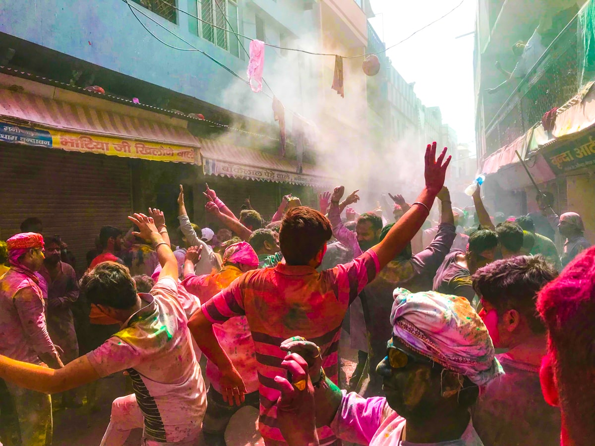 Crowds dancing in the streets celebrating The Holi Festival in Vrindavan and Mathura 