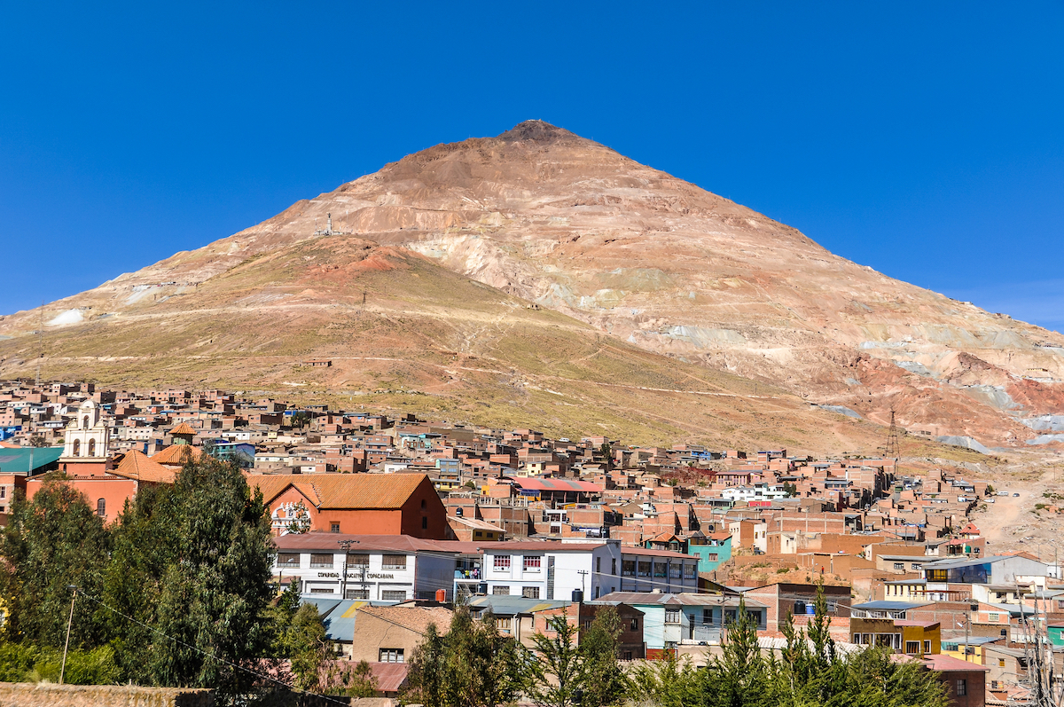 A brown mountain towers over a busy neighbourhood in La Paz, Bolivia.