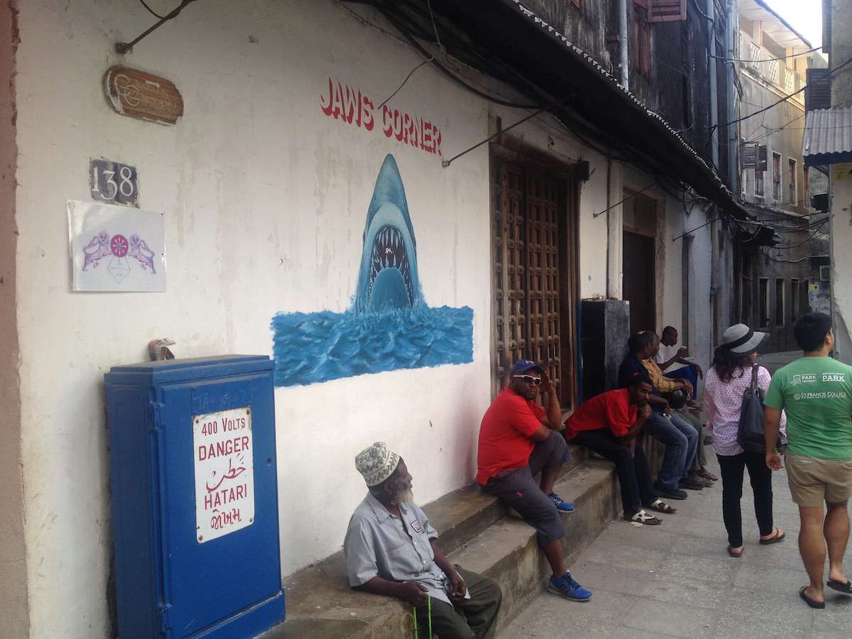 People sitting in a narrow street in Zanzibar 