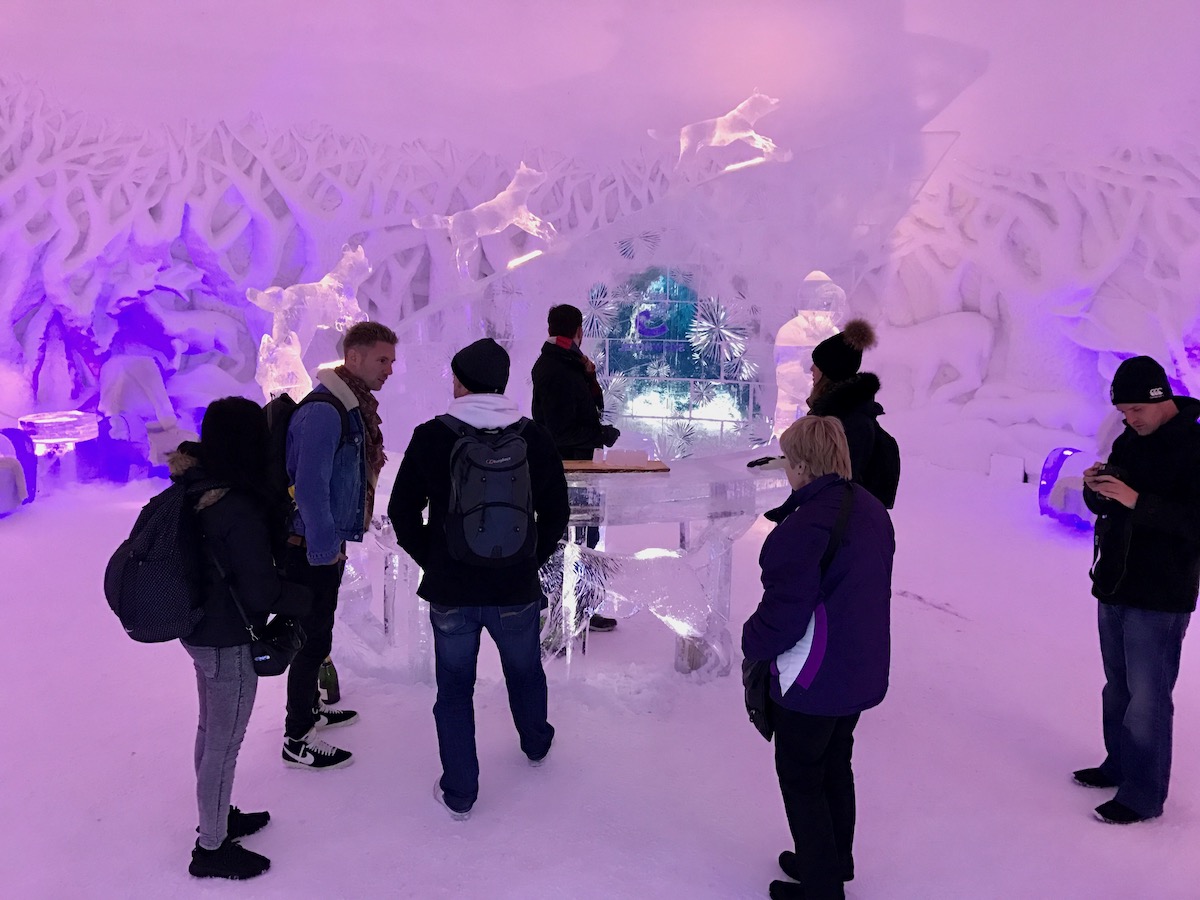 A group of tourists in an ice bar in the Snowhotel of Kirkenes in Norway's Arctic Circle.